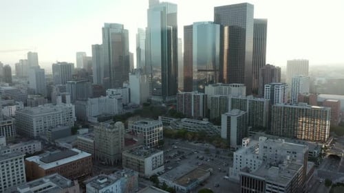 Slow Tilt Up Revealing Huge City Skyline with Multiple Towers and Office Buildings Scenic Aerial