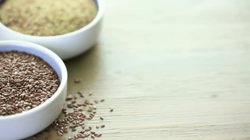 Flax seeds on painted wood board.