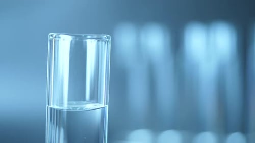 Liquid Drops into Clear Test Tube in Lab