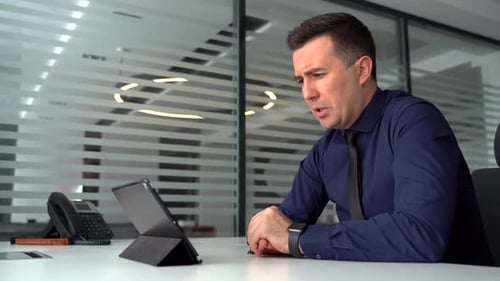 The Businessman Has a Business Meeting Video Call in the Office