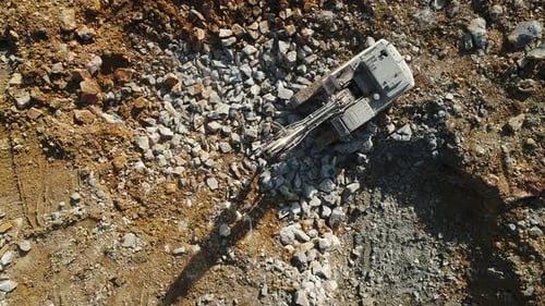 Aerial View of an Excavator Digging in Dirt
