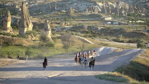 Group Riding Horses in a Rural Landscape