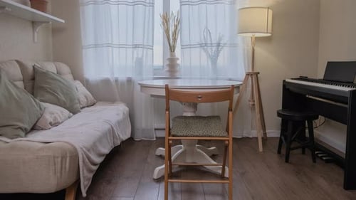 Placement of new furniture in an empty living room after moving into an apartment, stop motion