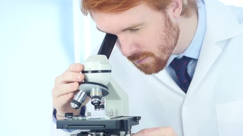 Scientist Using Microscope in Bright Modern Laboratory