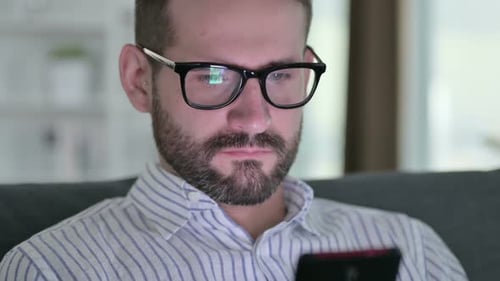 Close Up Serious Young Businessman Using Smartphone