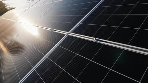 The Sun Reflects on the Surface of Solar Panels
