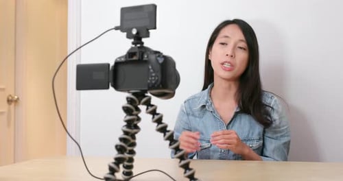 Woman Vlogging in Front of Camera and Monitor