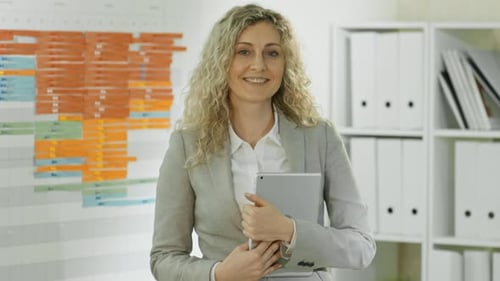 Curly Businesswoman with Tablet