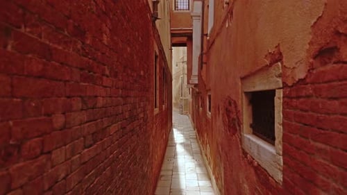 Cobblestone Sidewalk Between Old Shabby Brick Building Walls