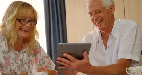 Senior Couple Enjoys Tablet Together at Home