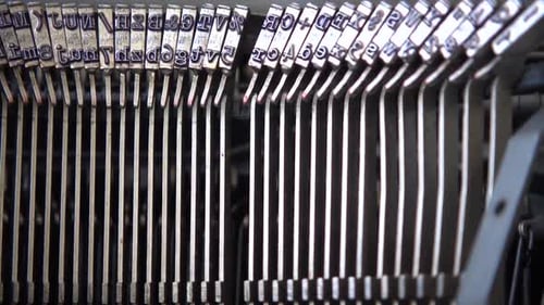 Mechanism of a retro typewriter. Old typewriter hammers. Close up. Slow motion.