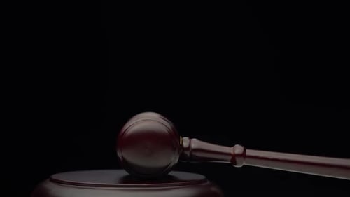 Wooden Judge's Hammer on the Stand. Black Background