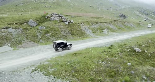 Aerial View of 4X4 Car Driving Off Road Along Mountain Slope