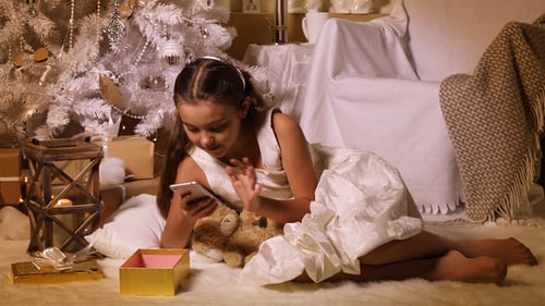 Girl Sleeping by Christmas Tree with Presents