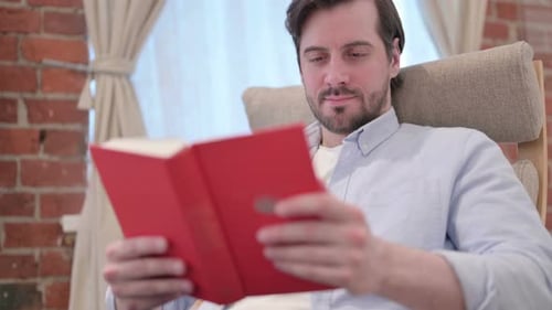 Man Reading a Book in Rocking Chair