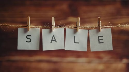 Sale Sign on Paper with Clothespins