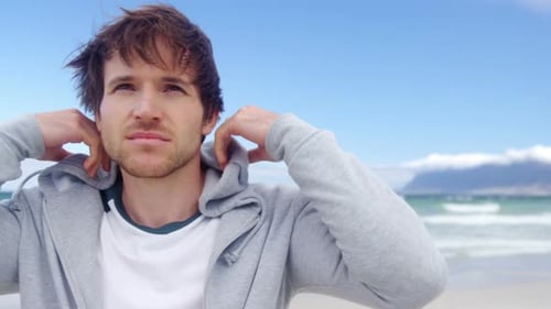 Man wearing hoodie at beach