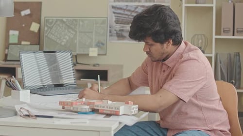 Biracial Architect Working on Design Project in Office