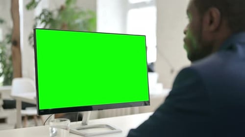 Man Using Desktop with Green Chroma Key Screen