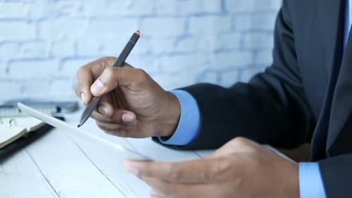Business Professional Using Digital Pen on Tablet