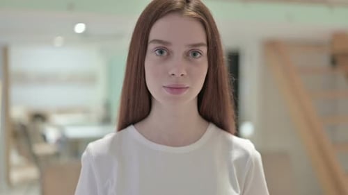 Portrait of Redhead Young Woman Looking at the Camera