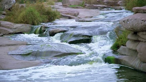 A Small Shining Stream Flows Among Smooth Wet and Dark Stones