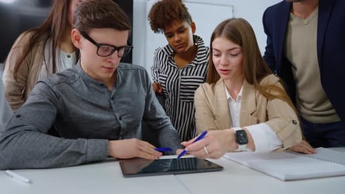 Diverse Team Brainstorms Together in Modern Office