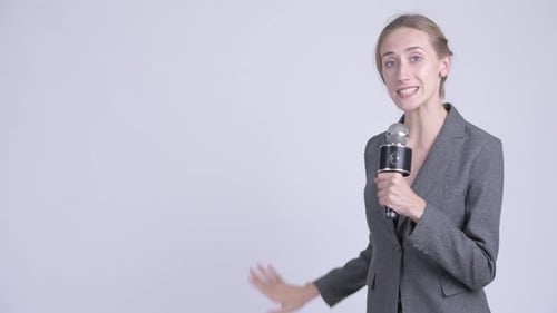 Woman Speaking into Microphone with Hand Gestures