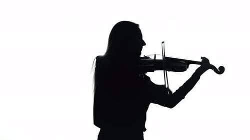 Young Woman Playing Violin in White Studio. Silhouette