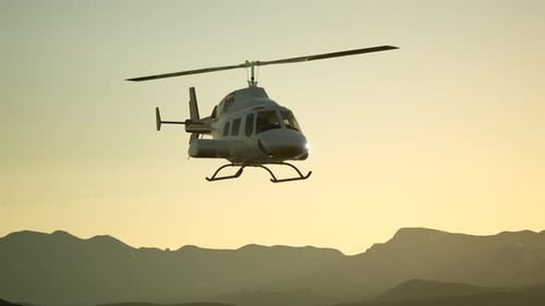 Helicopter Flying Over Mountains at Sunrise Animation