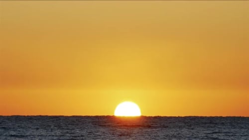Sunrise Over the Sea. Amazing Red Sunrise on the Beach. Orange Color of Sunrise and Waves. Yellow