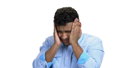 Man Experiencing Headache or Migraine on White Backdrop