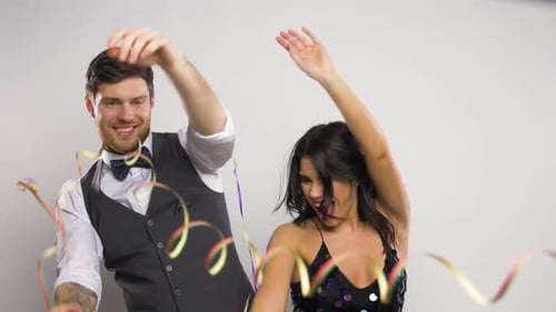 Happy Man and Woman Celebrating with Confetti