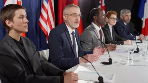 Officials at International Press Conference Speaking at Table