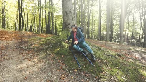 Man Hiking in Forest Taking a Rest