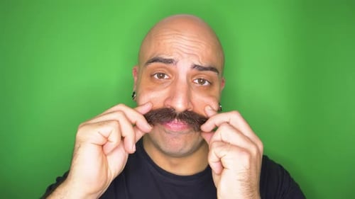 Portrait of smiling man twirling his moustache