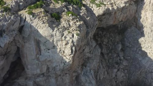 AERIAL: Beautiful Drone Shot of Cliff and Blue Water Waves Crushing on Tropical Island Mallorca