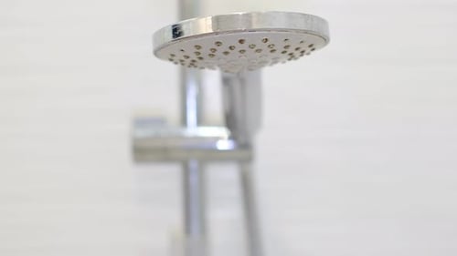 Turning on and Off Shower Head in Bathroom Water Flow in Front of Camera Falling Drops in Slow