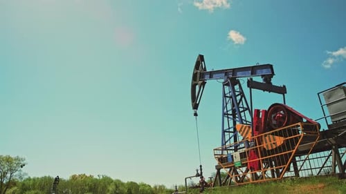 Oil Pump Jack Working on Sunny Day