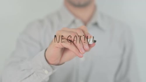 Hand Writes Negative on Clear Surface with Marker