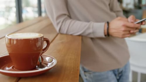 Man using mobile phone in coffee shop 4k