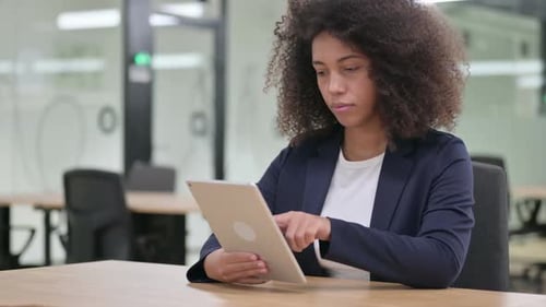 Businesswoman Using Tablet in Bright Modern Office