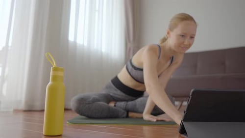 Woman Doing Yoga Using Tablet in Home