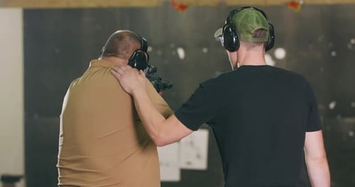 Man Receives Shooting Instruction at Indoor Range
