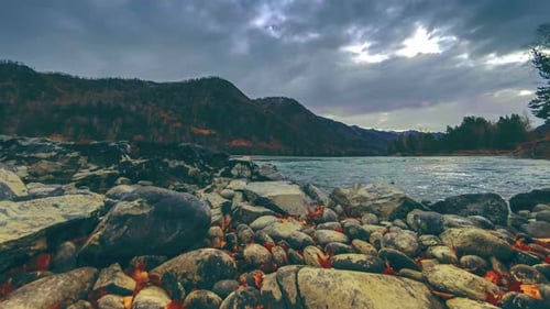 Time Lapse Shot of a River Near Mountain Forest. Huge Rocks and Fast Clouds Movenings. Horizontal