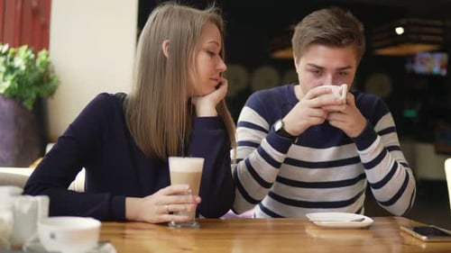 Young Couple Sittin in Cafe