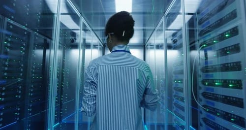 Ethnic Female Engineer with Tablet Diagnosing Server Hardware