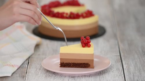 Cutting into a Decadent Layered Cake Slice