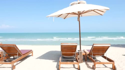 Beautiful tropical sea beach around with umbrella chair on blue sky