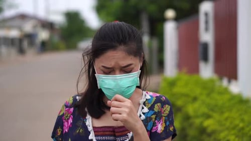 Woman Coughing and Wearing a Face Mask